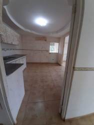 Traditional kitchen with tiled walls, granite counter, natural light in house for sale Chitré Panama