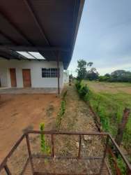 Exterior side of house with porch, garden and countryside view Chitré Panama