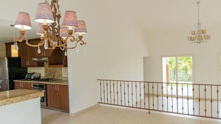 Contemporary kitchen with granite counters, wooden cabinets at Tucán Panama Pacifico