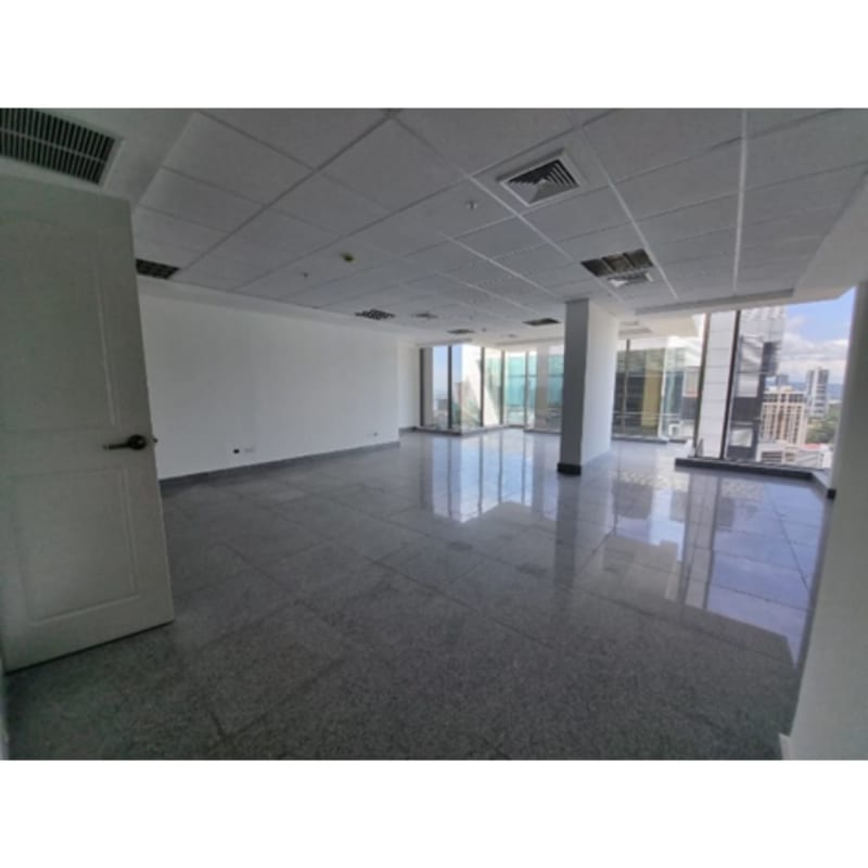 Compact commercial office bathroom with gray tiles white sink and toilet in Twist Offices Obarrio