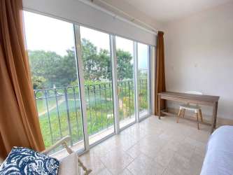 Bedroom with large sliding doors to balcony full of sunlight in luxury apartment Puntarena Buenaventura Panama