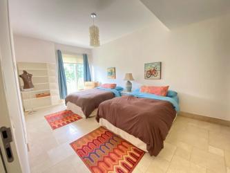 Stuffed double bedroom with large window colorful decor in luxury condo Puntarena Buenaventura Panama