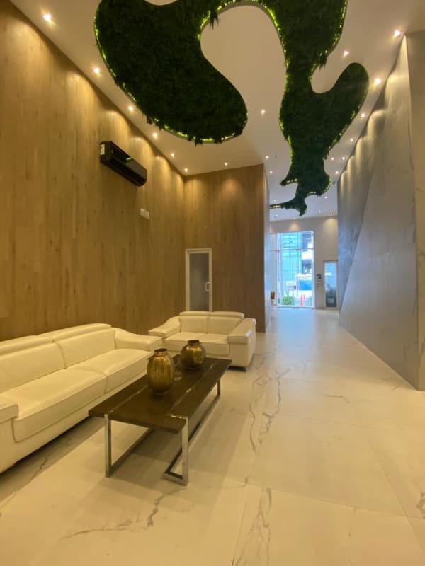 Fitness center with yellow accent wall, treadmills, elliptical and bike PH Green View Bella Vista