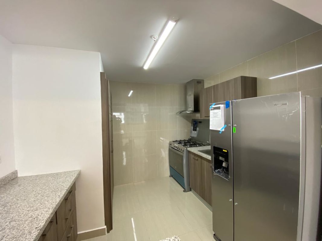 Bright kitchen with granite countertop, stainless appliances, white cabinetry in PH Green View Panama