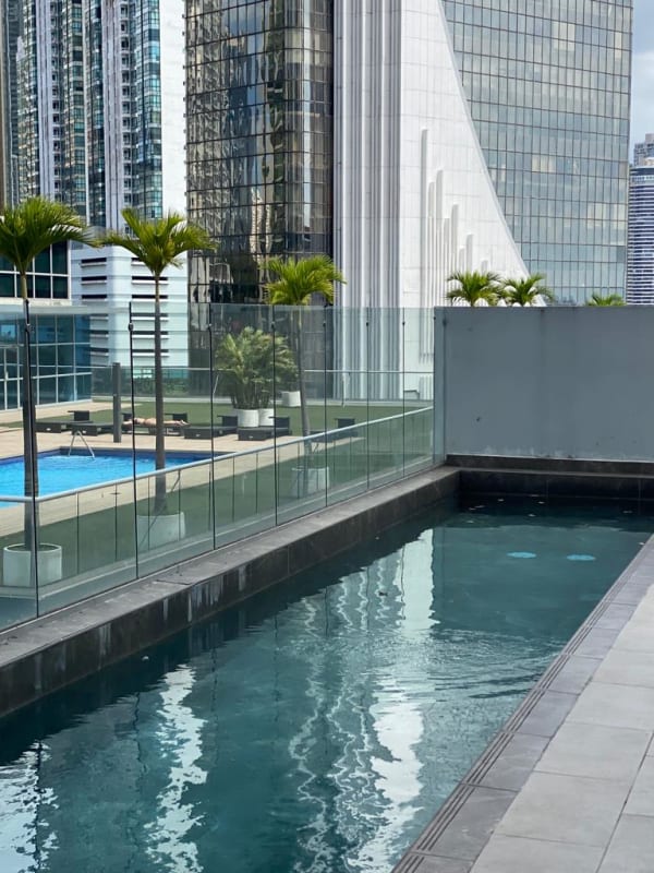 Skyline rooftop pool with glass railing overlooking ocean and skyline in PH Green View Panama