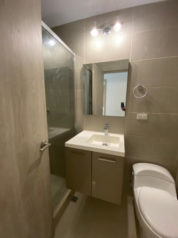 Modern minimalist bathroom with beige tiles, shower glass doors in PH Green View Panama