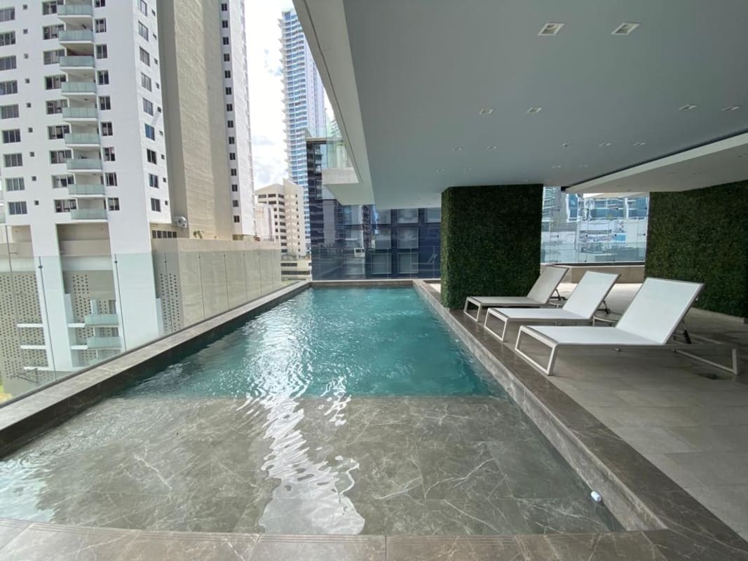 Outdoor swimming pool area with lounge chairs atop PH Green View Bella Vista Panama