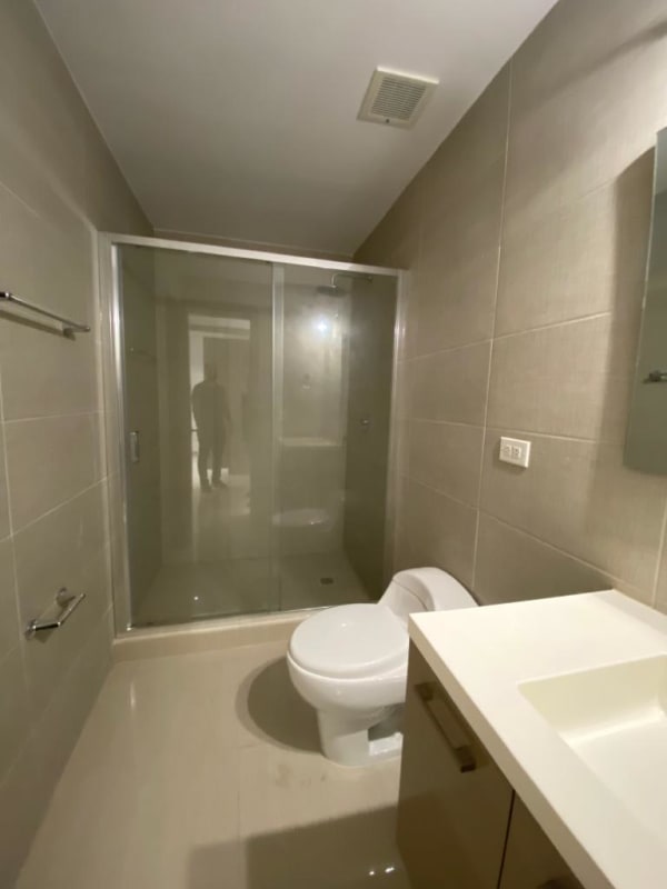 Modern bathroom with single vanity and glass shower enclosure at PH Green View Bella Vista Panama