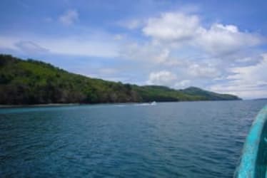 Secluded beachfront with ocean and green hills on Isla Cébaco Panama, ideal for eco-resort investment