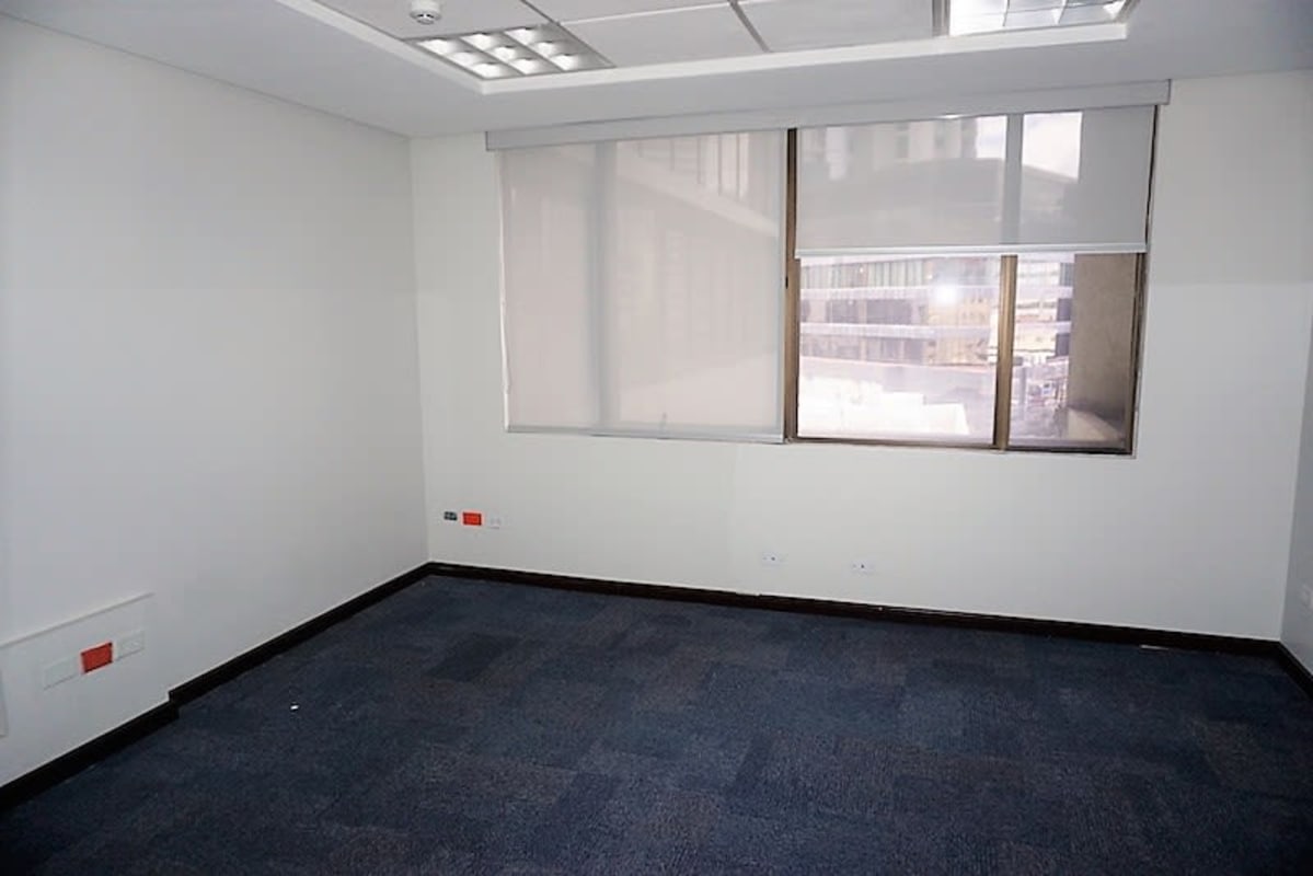 Large open corporate office with blue carpet and city views PH BICSA Obarrio Panama