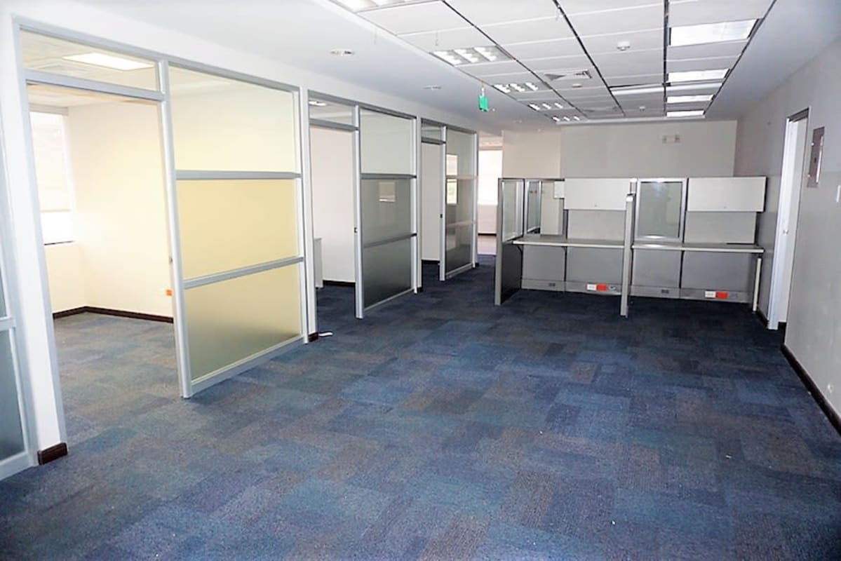 Glass partitioned office with blue carpet in PH BICSA Tower in Obarrio, Panama