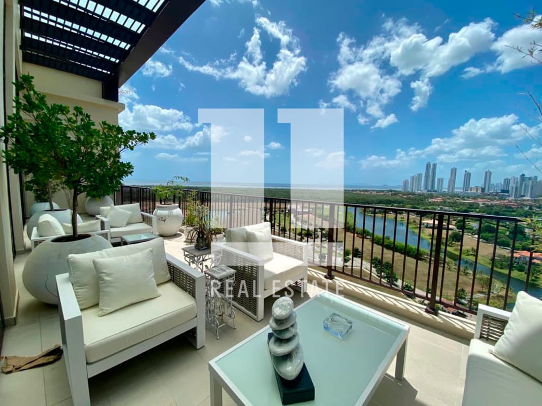 Balcony terrace with lounge chairs, skyline and sunset water views at Santa Maria Penthouse Panama