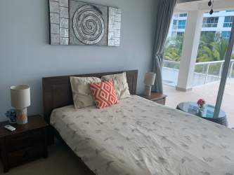 Modern bedroom with balcony access and ocean view at Playa Blanca Condo Panama