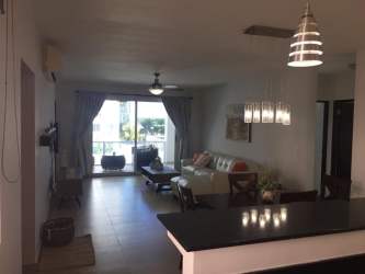 Bright living dining room with balcony access at Playa Blanca condo Panama