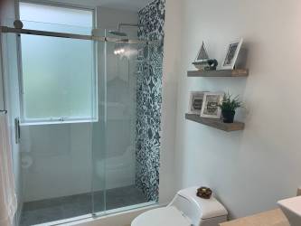 Covered balcony with seating and ceiling fan at PH Terrazas Villas Playa Blanca Panama