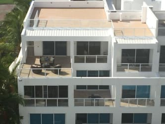 Modern beachfront condo building with balconies at PH Terrazas Villas Playa Blanca Panama