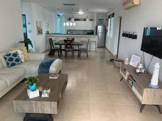 Spacious living room combined with kitchen, dining at Playa Blanca condo Panama