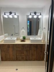 Contemporary bathroom with double sinks and wood cabinetry Playa Blanca Panama