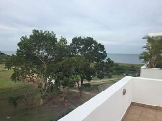 Balcony overlooking ocean and lush greenery at Playa Blanca condo Panama