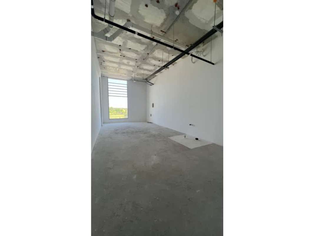 Unfinished open space with white walls, exposed ceiling ducts, big window Costa del Este Panama