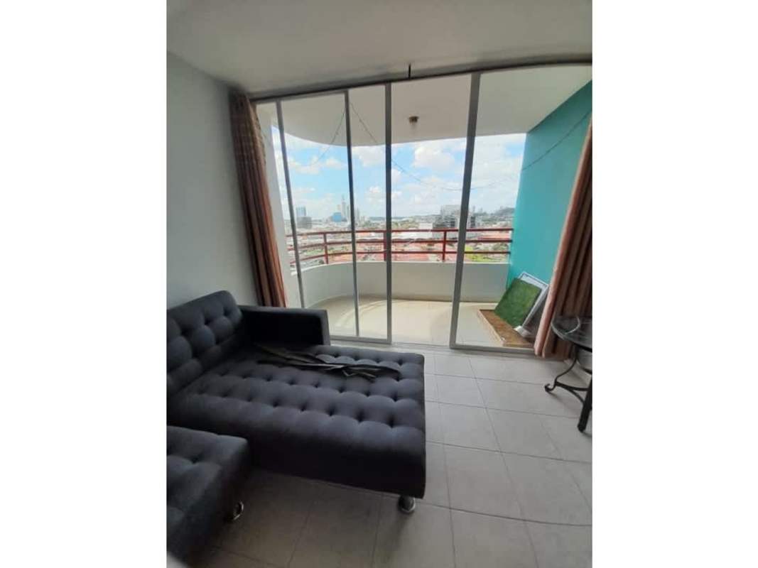 Living room with balcony access overlooking city skyline in PH Marquez Panama City