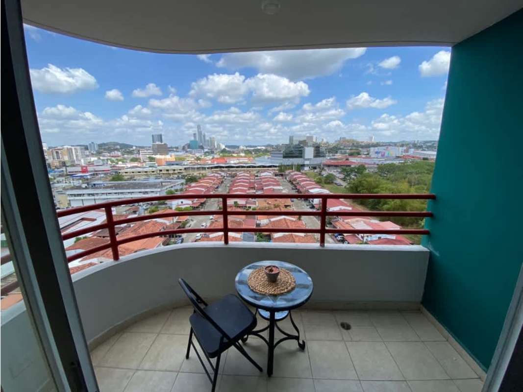 Kitchen with granite counters, stove, microwave, and wood cabinetry in PH Marquez Panama City
