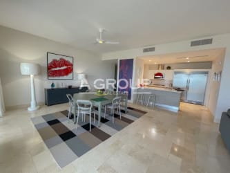 Dining area with sliding doors, oceanfront balcony access at Puntarena Buenaventura condo Panama