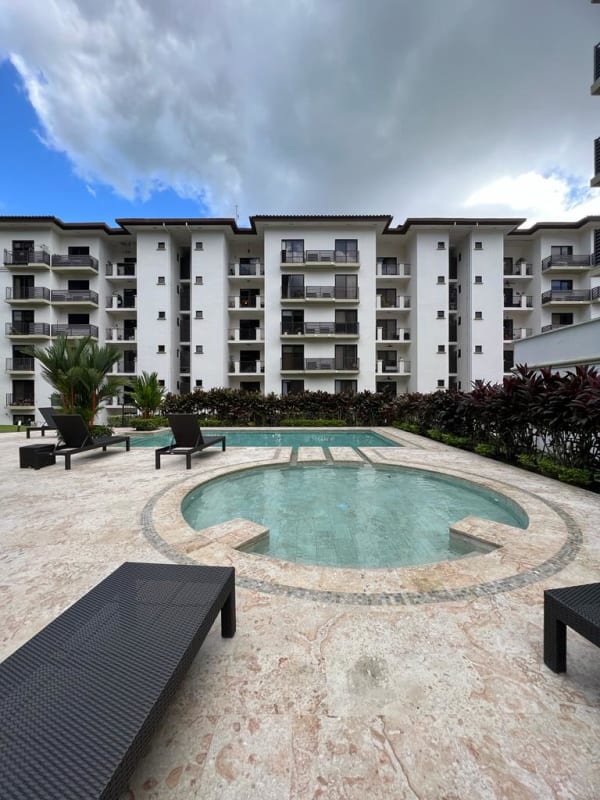 Pool area with umbrellas, seating and garden Embassy Village Clayton Panama