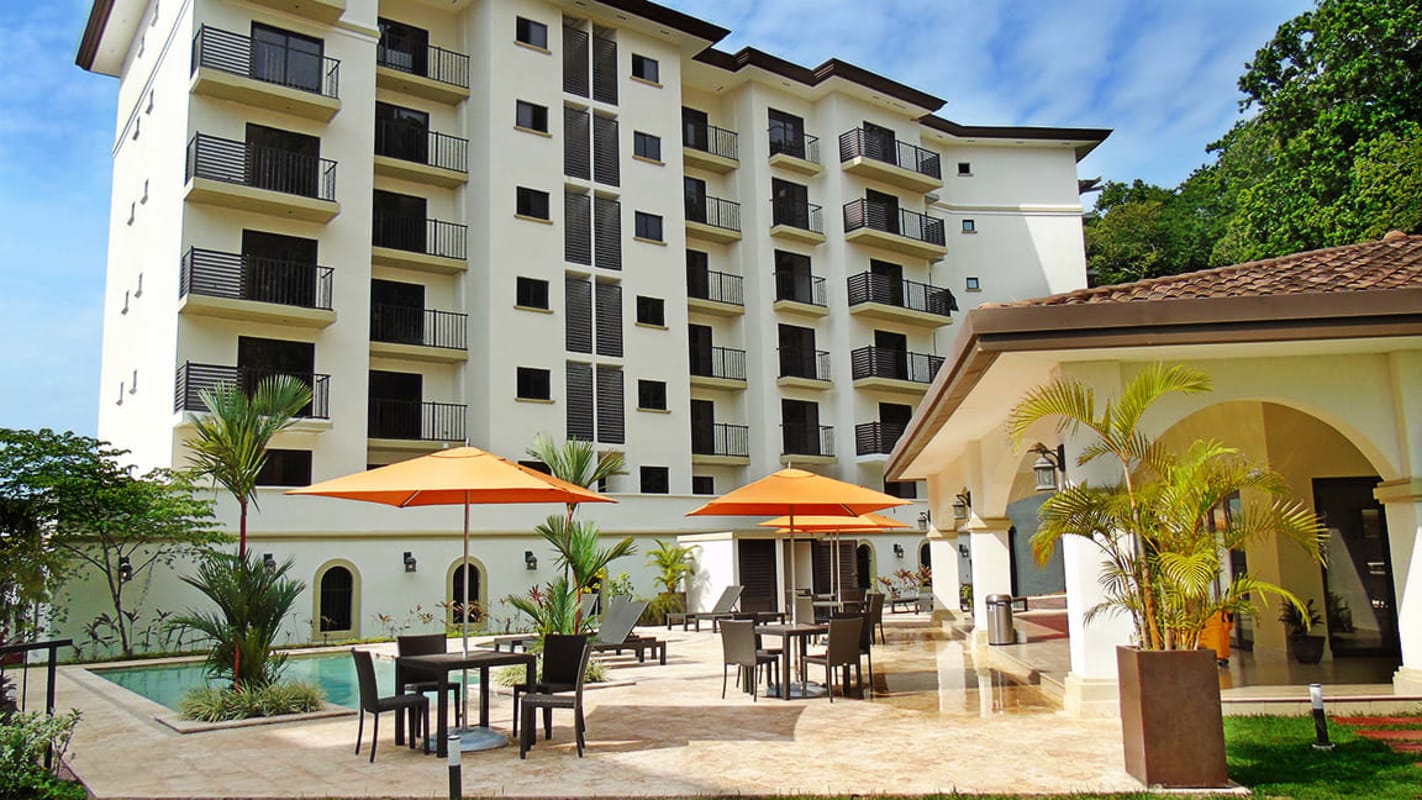 Large bedroom with carved wooden bed set Embassy Village Clayton Panama