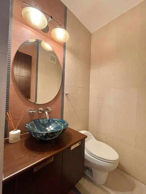 Bathroom with vessel sink, round mirror, wood vanity PH Infinity San Francisco Panama