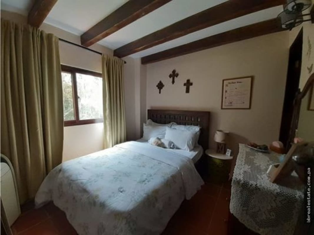 Open kitchen with rustic tile counters, wooden accents, appliances mountain home Cerro Azul Panama