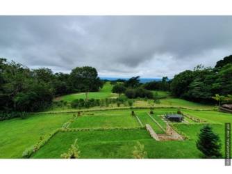Expansive mountain-view terrace with tiled floors, stone fireplace in Lucero Boquete property