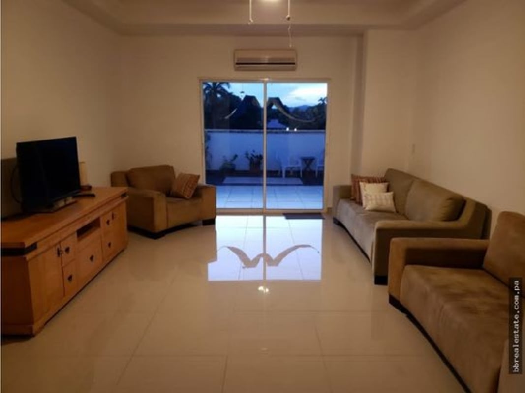 Modern living area with natural light, tile flooring and sliding glass doors to terrace at PH Provenza Diablo Panama