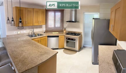 Open gourmet kitchen with granite countertops wood cabinetry at Tucan Country & Golf Club Panama