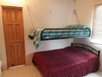 Kitchen with rustic finishes, natural light, appliances included inside Costa Esmeralda beach house Panama