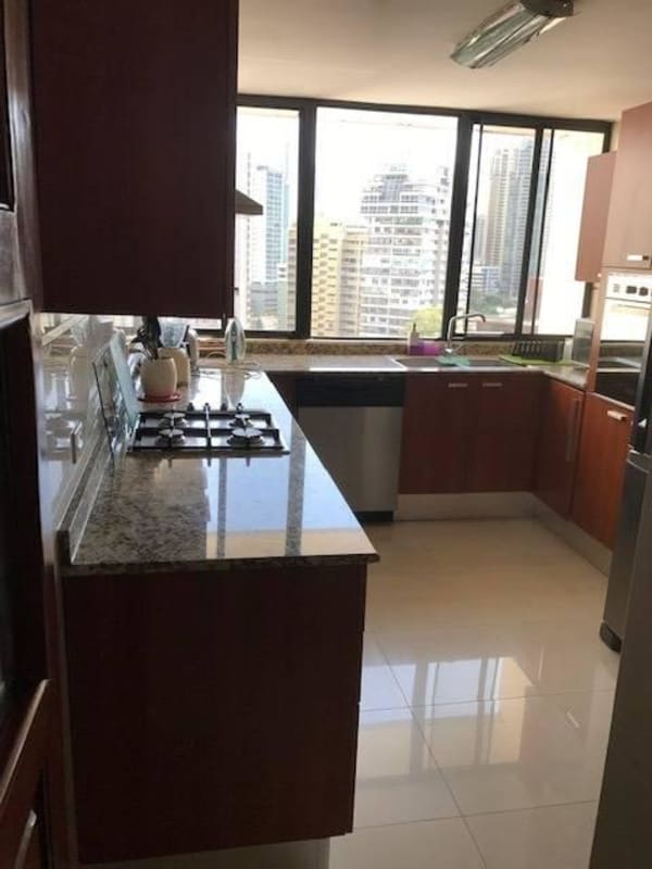 Modern kitchen with granite counters, stainless steel appliances, large windows ocean view PH BICSA