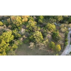 Aerial image of wooded area with flat terrain and paved access corner land Panama