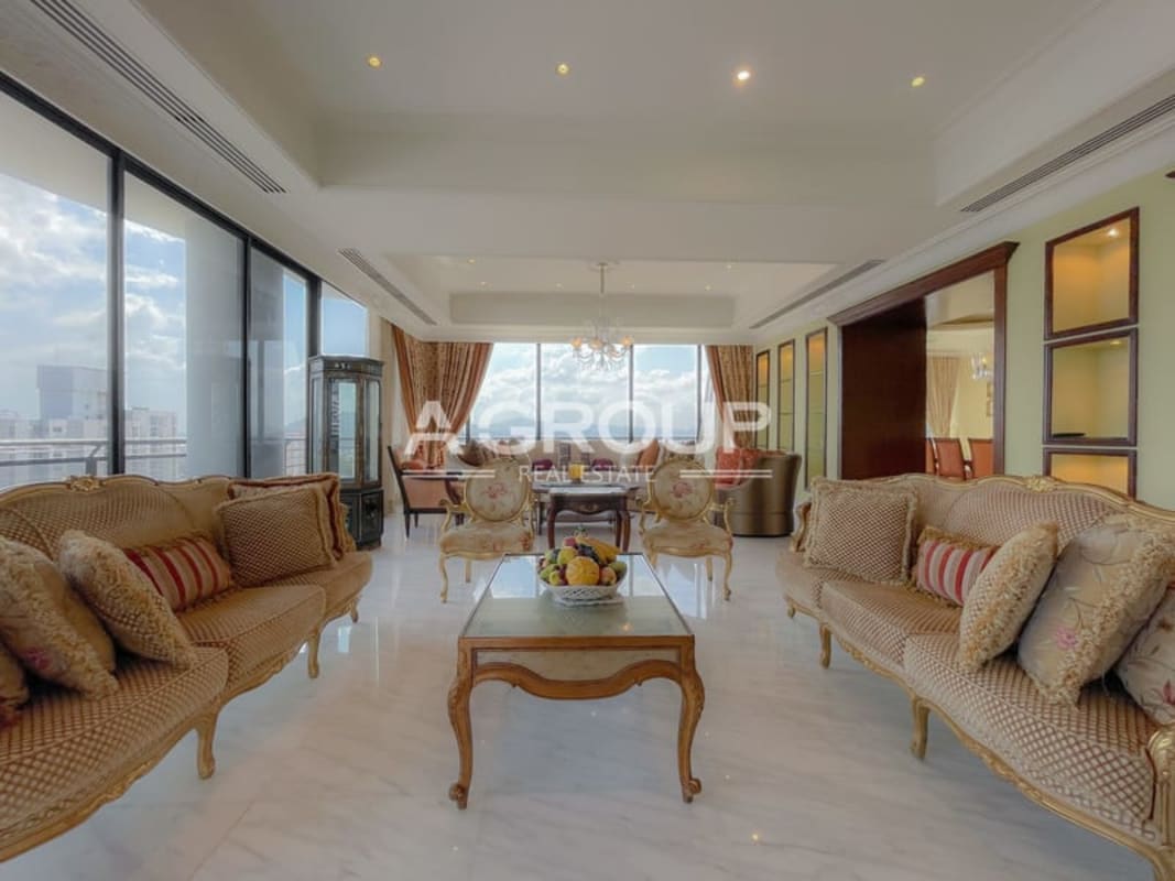 Luxury living room with marble floors, chandelier, panoramic skyline views Torre Imperial Panama