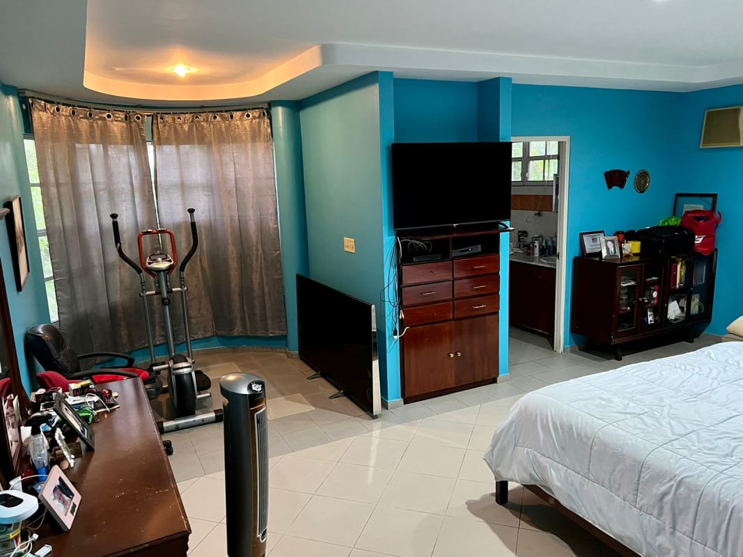 Cozy corner nook with armchairs blue curved wall big windows Las Cumbres Panama