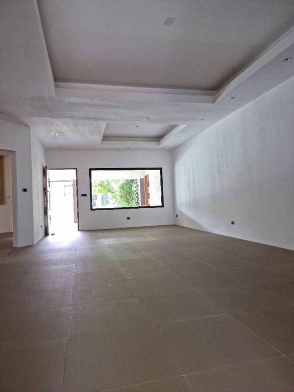 Open plan living room with tile floors and natural light luxury house in Brisas del Golf