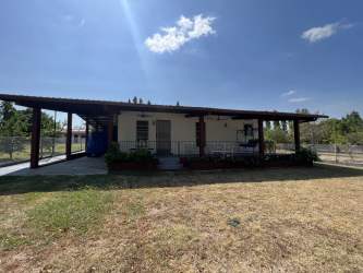 Bedroom with tile flooring, air conditioning, and garden views in Coronado Panama home