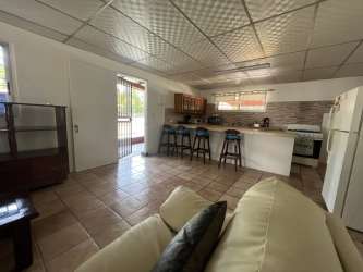 Open plan living and dining area with tile floors in Coronado house with pool Panama