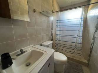Open kitchen with breakfast bar and tile countertops in Coronado beach house Panama