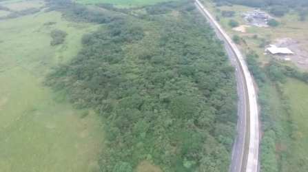 Aerial image of development site with vegetation and adjacent warehouses along Interamericana Penonomé Panama