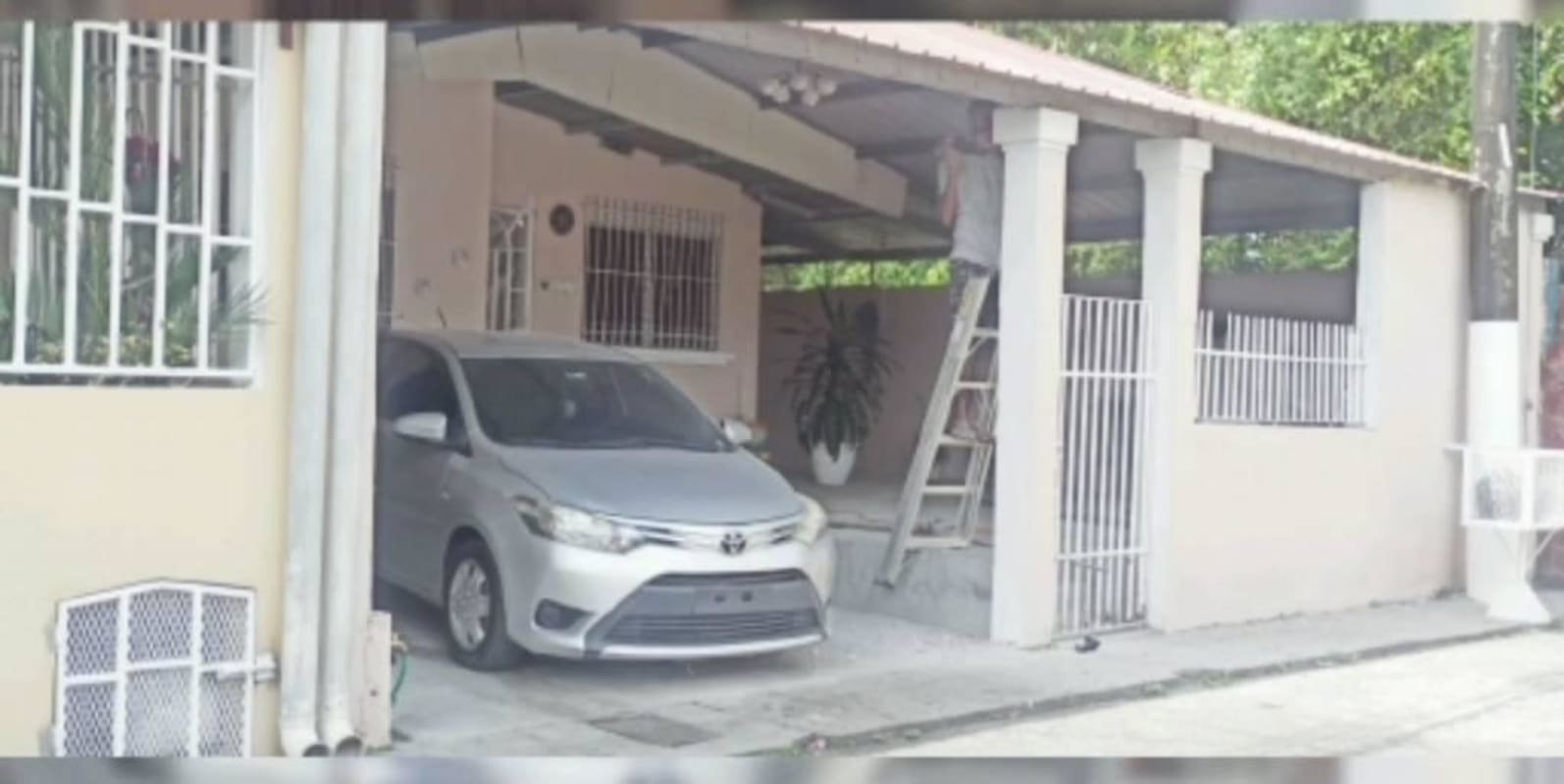 Cozy living room featuring brick accent wall, sectional sofa and modern decor in Villa Belén Tocumen Panama