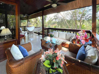 Rustic style bedroom featuring vaulted wood ceilings, large windows, nature views at Brisas de los Lagos La Chorrera