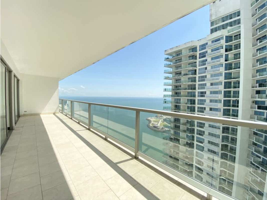 Modern kitchen with built-in appliances, dining space, marble floors at The Ocean Club Punta Pacifica Panama