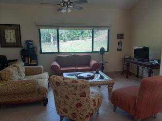 Bright living and dining space with sliding glass doors and mountain views in Altos del María Panama