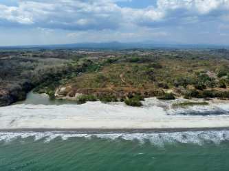 Aerial closeup of El Veladero San Carlos Panama land featuring beach, Pacific Ocean, Coton River border