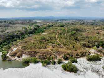 Aerial of oceanfront land and vegetation near Playa El Veladero prime for development in Panama